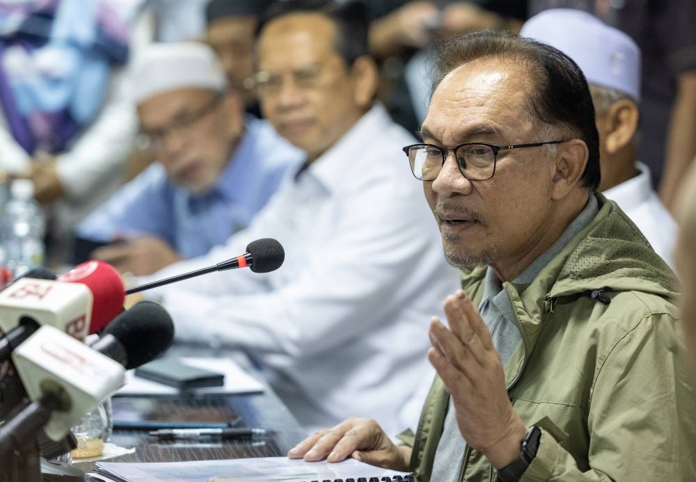 Prime Minister Datuk Seri Anwar Ibrahim speaks at a press conference after visiting the temporary relief centre at Sekolah Menengah Kebangsaan Tengku Panglima Raja in Kelantan, December 21, 2022. — Bernama pic