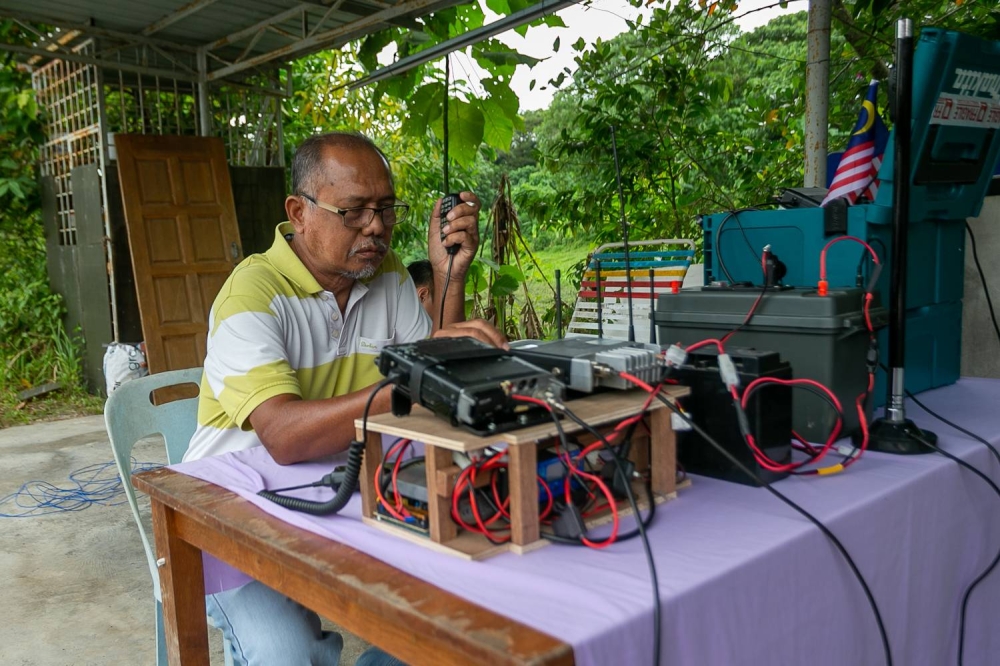 MARTS emergency and disaster communication centre head coordinator Hamdan Haji Abu, testing his radio equipment in front of his house in Semenyih. — Picture by Raymond Manuel.