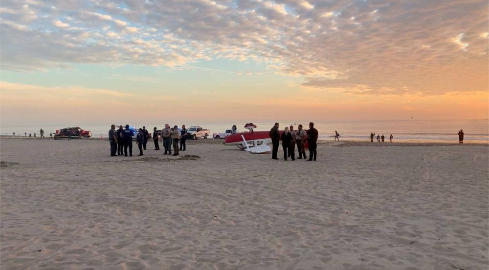 Emergency personnel stand near a plane after a small plane crashed at Santa Monica Pier beach, in Santa Monica, California December 22, 2022  in this screengrab obtained from a social media video. — Jackson Brunner pic via Reuters