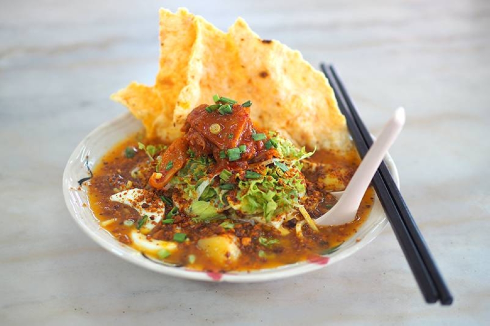 Restoran Wan Shoon's Mee Jawa is a melange of sweet, spicy and sour flavours from its thick gravy mixed with the yellow noodles and served with crackers and toasted ground peanuts.