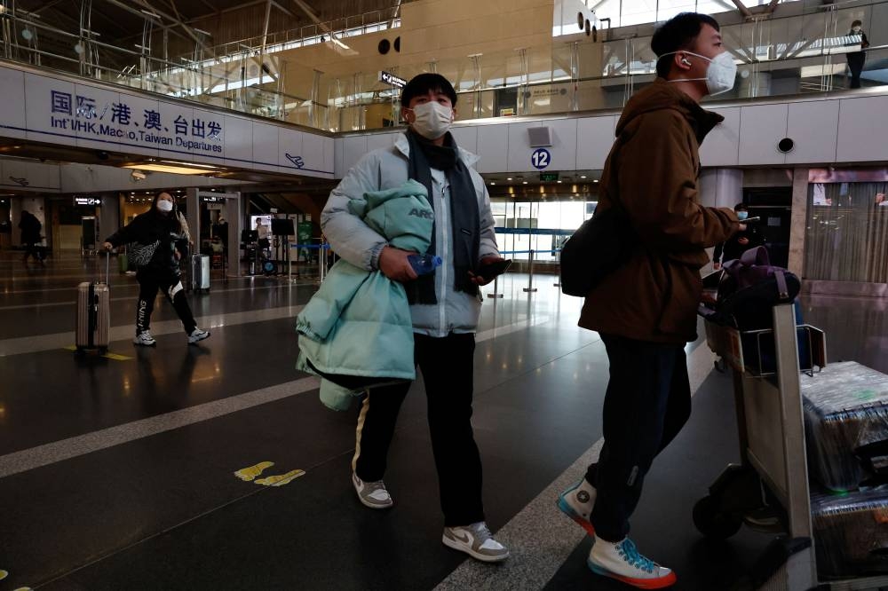 Travellers walk with their luggage at Beijing Capital International Airport in Beijing, China December 27, 2022. ― Reuters pic