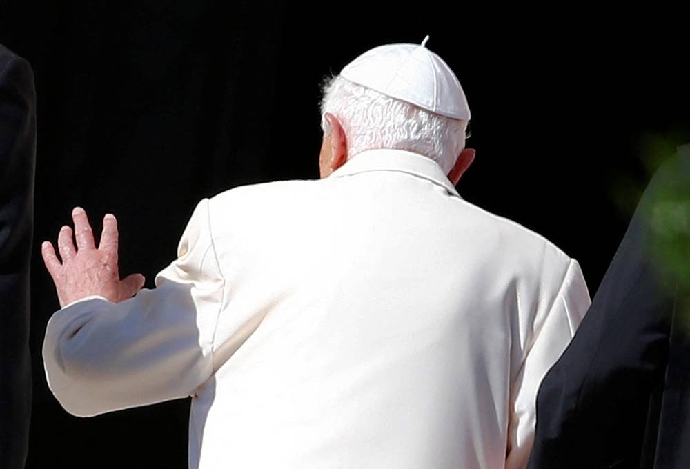 Pope Emeritus Benedict XVI waves as he leaves after attending a gathering of elderly people in Saint Peter's square at the Vatican September 28, 2014. — Reuters pic