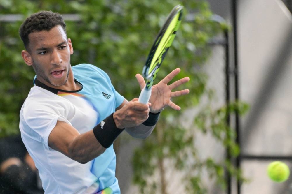 Canada's Felix Auger-Aliassime hits a return against Australia's Alexei Popyrin during their men's singles match at the Adelaide International tennis tournament in Adelaide on January 2, 2023. — AFP pic