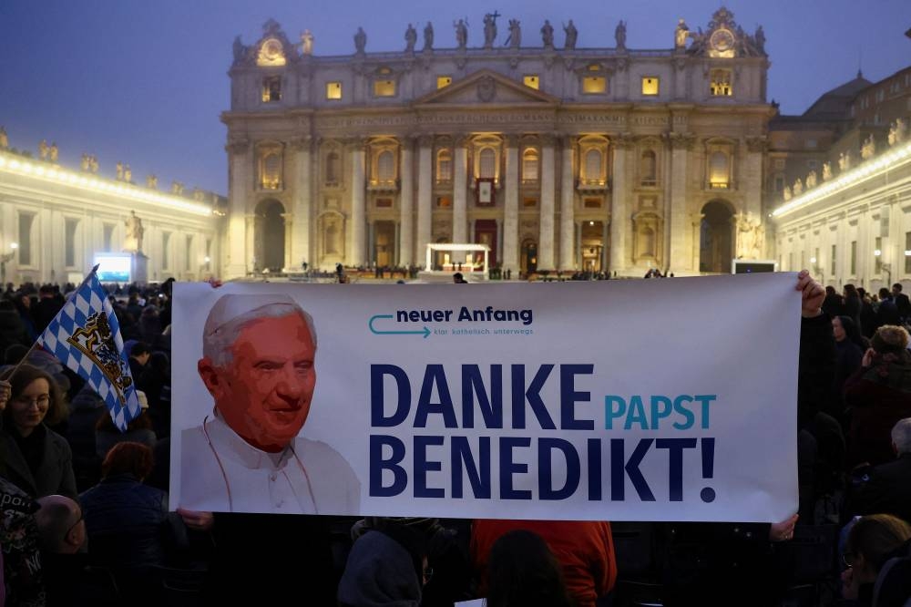 Faithful wait to enter St Peter’s Square on the day of the funeral of former Pope Benedict at the Vatican, January 5, 2023. The banner reads ‘Thank you Pope Benedict’. — Reuters pic