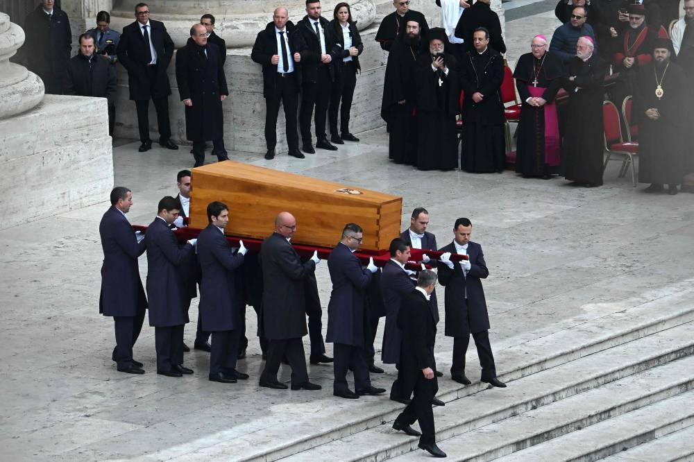 Pallbearers carry the coffin of Pope Emeritus Benedict XVI at the start of his funeral mass at St Peter's square in the Vatican, on January 5, 2023. — AFP pic