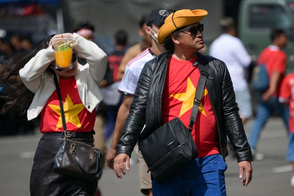 Vietnamese football fans arrive to support their team before the AFF Mitsubishi Electric Cup 2022 football match between Indonesia and Vietnam at Gelora Bung Karno Stadium in Jakarta on January 6, 2023. — AFP pic