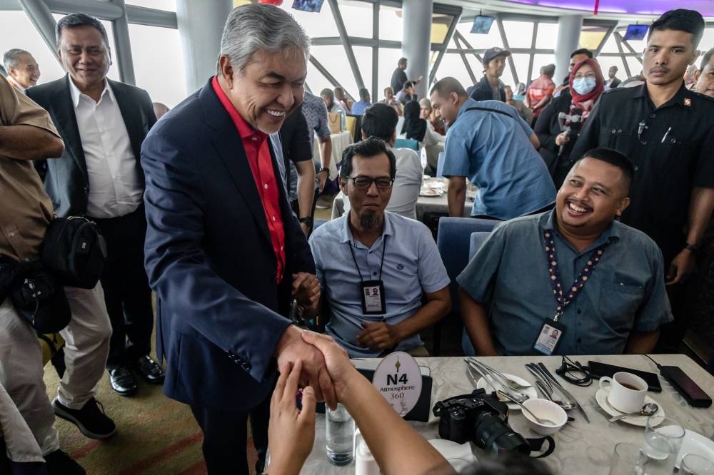 Datuk Seri Ahmad Zahid Hamidi greets reporters at Menara Kuala Lumpur January 10, 2023. — Picture by Firdaus Latif