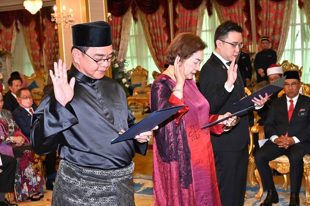 Sabah assemblymen (from left) Datuk James Ratib, Datuk Christina Liew and Ginger Phoong take their oaths of office as members of the new Sabah Cabinet in Kota Kinabalu January 11, 2023. — Picture courtesy of the Sabah Chief Minister’s Department