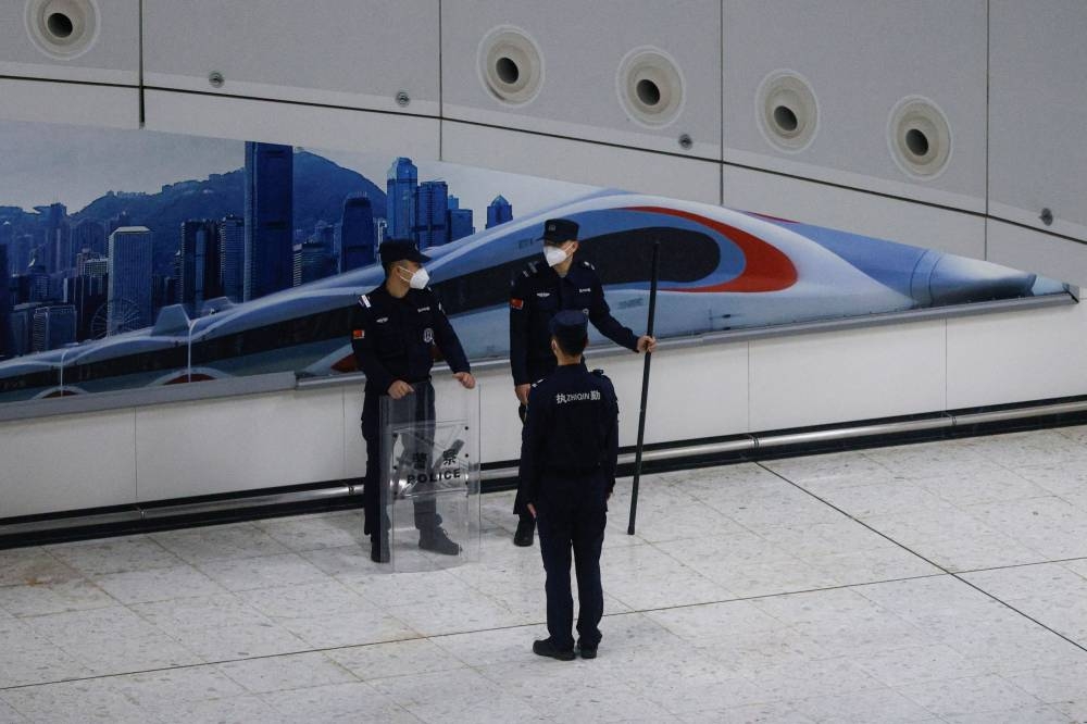 A Chinese police officer stands guard at in the mainland port area of West Kowloon High-Speed Train Station Terminus on the first day of the resumption of rail service to mainland China, during the coronavirus disease (Covid-19) pandemic in Hong Kong, China, January 15, 2023. — Reuters