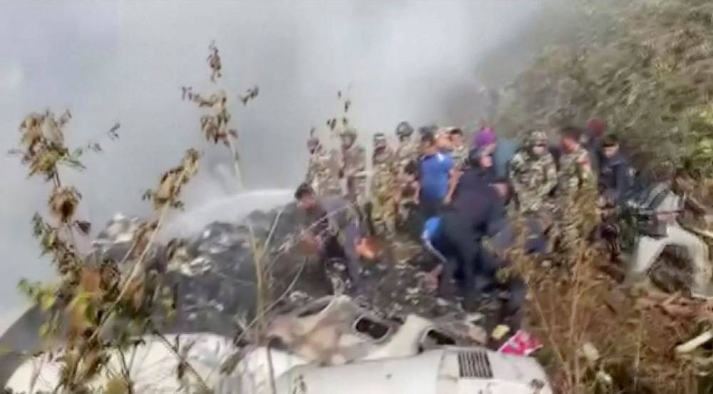 Rescuers work at the site of a plane crash in Pokhra, Nepal January 15, 2023, in this screen grab taken from a handout video. — ANI handout pic via Reuters