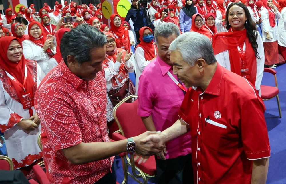 Umno President Datuk Seri Dr Ahmad Zahid Hamidi shakes hands with Deputy Head of Rembau Umno Division, Khairy Jamaluddin (left) when attending the Women Umno General Assembly in conjunction with the 2022 Umno General Assembly at the Kuala Lumpur World Trade Center (WTCKL) January 12, 2023. — Bernama pic