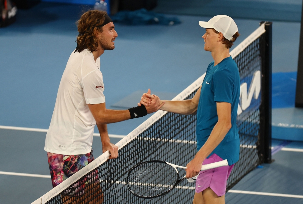 Greece’s Stefanos Tsitsipas shakes hands with Italy’s Jannik Sinner during the Australian Open at Melbourne Park, Melbourne, January 22, 2023 ― Reuters pic