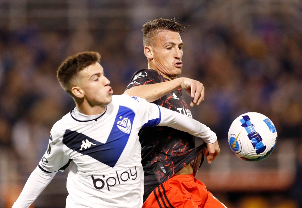 Velez Sarsfield's Maximo Perrone in action with River Plate's Braian Romero on June 29, 2022. — Reuters file pic