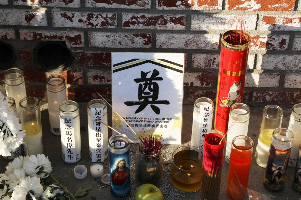 Candles and mementos are left at the entrance of the Star Ballroom after a mass shooting during Chinese Lunar New Year celebrations in Monterey Park, California  January 24, 2023. — AFP pic