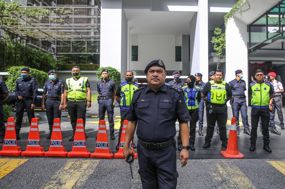 Police officers stand guard as protester gather outside Swedish embassy during a demonstration to condemn the burning of a copy of Muslim holy book in Kuala Lumpur January 27, 2023. — Picture by Yusof Mat Isa