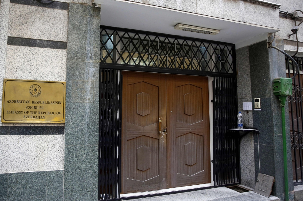 Bullet holes are seen at the door of the Azerbaijan embassy in Tehran on January 27, 2023, following an attack. — AFP pic