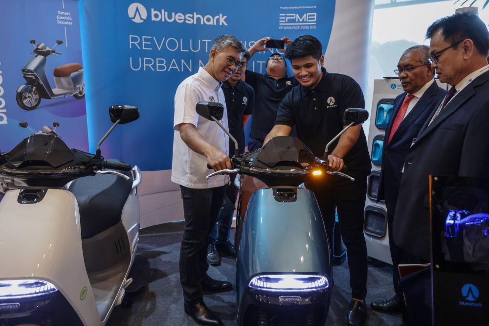 Datuk Seri Tengku Zafrul Tengku Abdul Aziz (left) officiates the Electric Vehicles Conference 2023 at the Mida Tower in Kuala Lumpur February 14, 2023. — Bernama pic