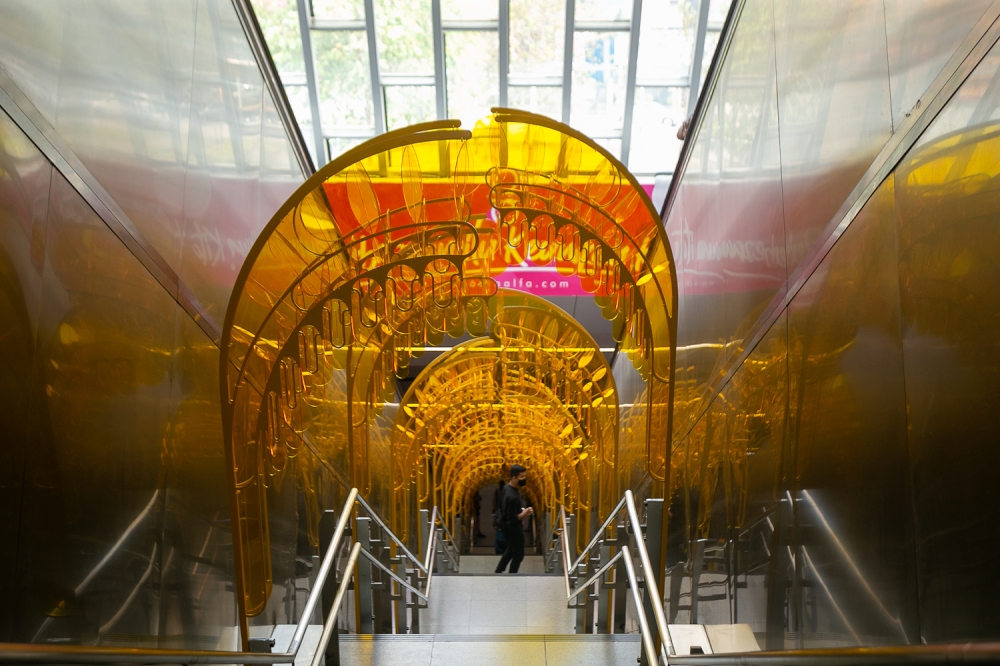 The clear acrylic structures amplify and reflect yellow light into an otherwise stark staircase. — Picture by Raymond Manuel