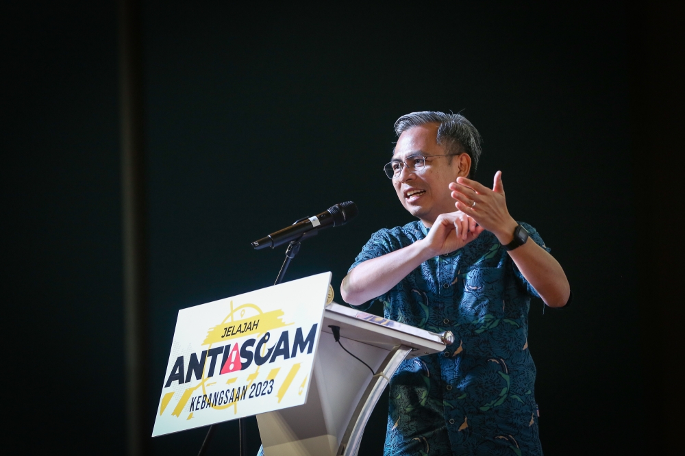 Communications and Digital Minister Fahmi Fadzil speaks during the National Anti-Scam 2023 programme at CelcomDigi Tower in Petaling Jaya February 18, 2023. — Picture by Yusof Mat Isa