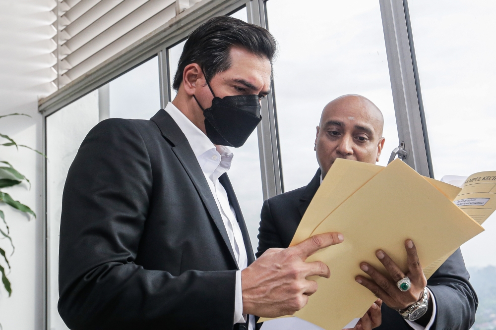 Segambut Bersatu deputy chief Adam Radlan Adam Muhammad (left) at the Shah Alam Court Complex February 22, 2023. — Picture by Sayuti Zainudin