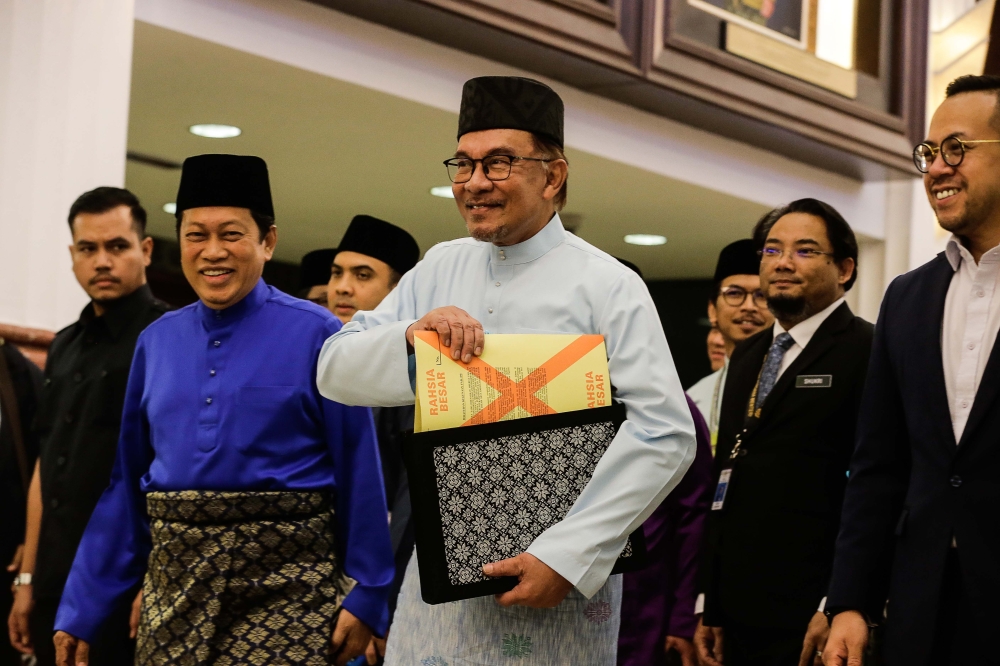 Prime Minister Datuk Seri Anwar Ibrahim is seen holding the Budget 2023 document in Parliamen building, February 24, 2023. — Picture by Sayuti Zainudin