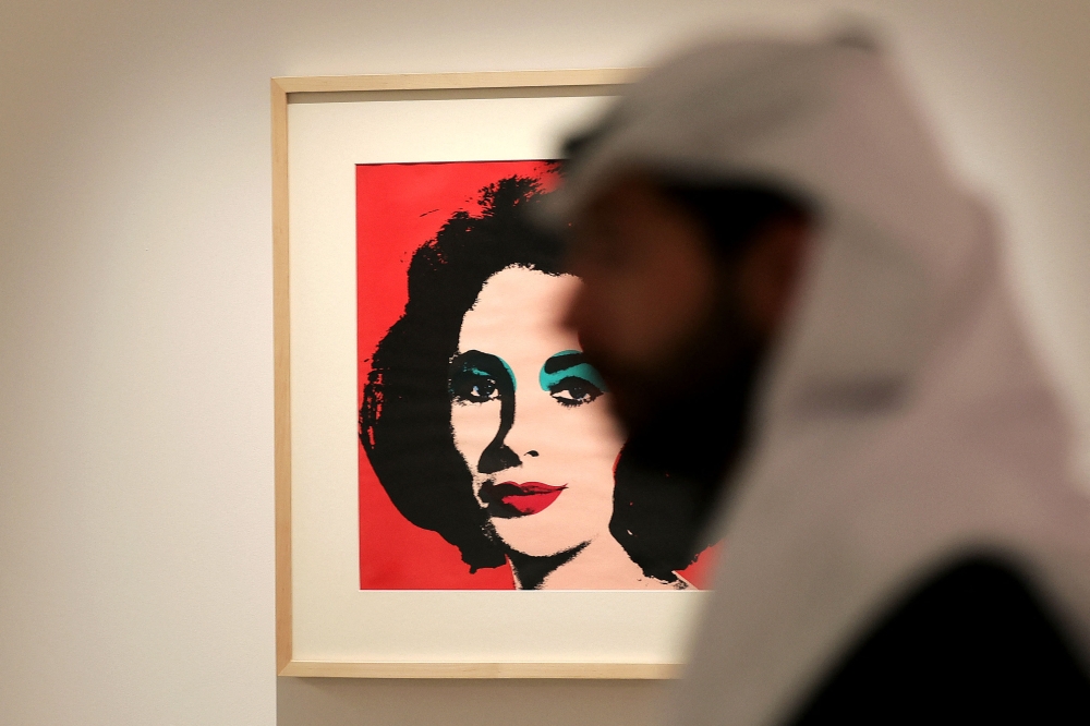 A Saudi man visits an arts exhibition by late US artist Andy Warhol at the Maraya concert hall in the ruins of Al‘Ula, a UNESCO World Heritage site in northwestern Saudi Arabia. — AFP pic