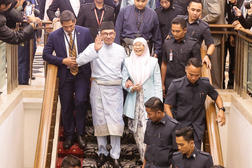 Prime Minister Datuk Seri Anwar Ibrahim along with his wife Datuk Seri Wan Azizah Wan Ismail are seen leaving after he had tabled Budget 2023 in Parliament, February 24, 2023. — Picture by Sayuti Zainudin