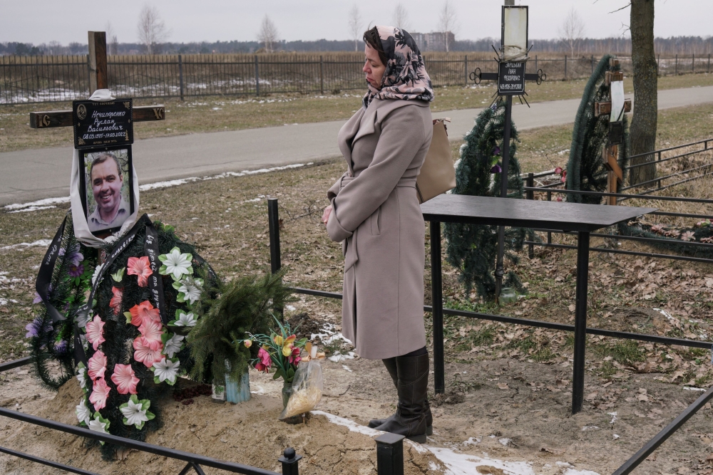 Alla Nechyporenko visits her husband’s grave. He was killed by a Russian soldier during occupation of the town of Bucha. — Reuters pic