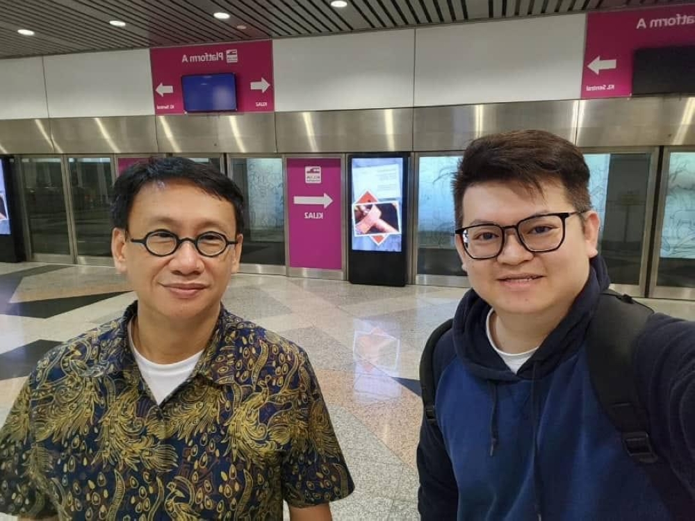 PKR’s Subang Jaya MP Wong Chen (left) and DAP’s Bandar Kuching MP Dr Kelvin Yii Lee Wuen wait for the KLIA Train to KL Sentral at the Kuala Lumpur International Airport (KLIA) March 6, 2023. — Picture via Facebook/Wong Chen