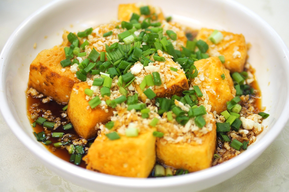 Choy Poh Tofu is creamy beancurd topped with crispy crunchy preserved radish