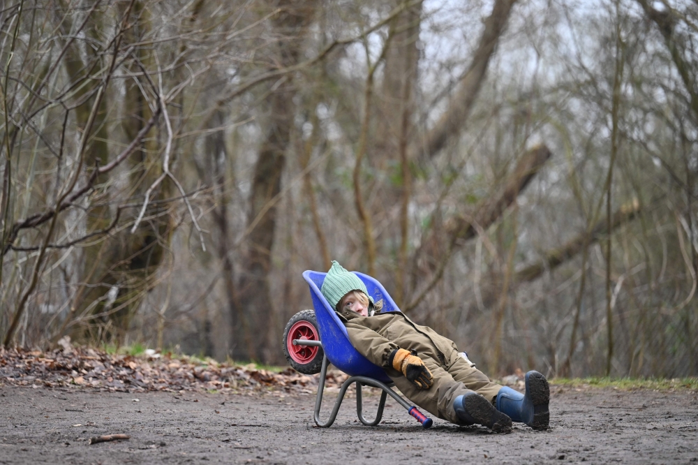 In this picture taken on February 7, 2023, a boy rests at a forest camp on the outskirts of Ballerup, Denmark. — AFP pic