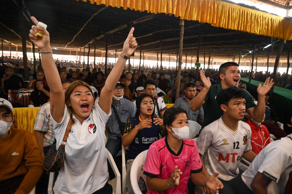 This photo taken on March 5, 2023 show people watching a traditional Myanmar boxing Lethwei tournament at Pyi Thar Lin Aye pagoda in Hlaingbwe township in Karen state. — AFP pic