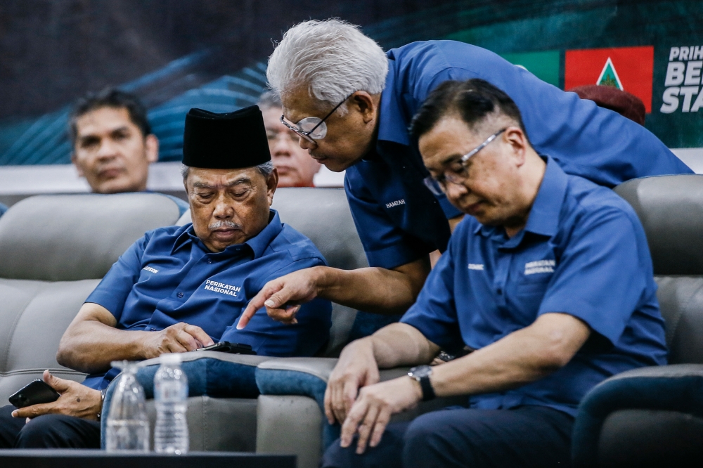 PN chairman Tan Sri Muhyiddin Yassin (left) together with Bersatu secretary-general Datuk Seri Hamzah Zainudin (centre) and Gerakan president Datuk Dominic Lau Hoe Chai (right) at the 'Solidarity Against Tyranny' ceramah at PAS Tarbiyah Centre in Gombak  March 11, 2023. — Picture by Hari Anggara