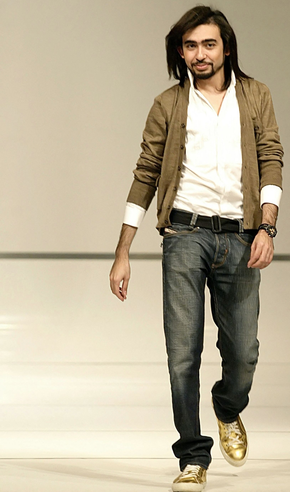 In this file photo taken on March 9, 2007 Young Saudi fashion designer Mohammed Ashi strolls onto the stage in Beirut following his show during the final of the TV program 