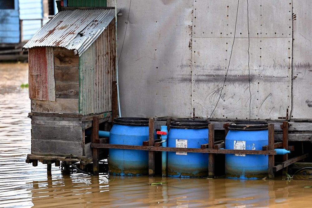 This photo taken on March 13, 2023 shows floating toilets in Chong Prolay village on Tonle Sap lake in Siem Reap province. — AFP pic