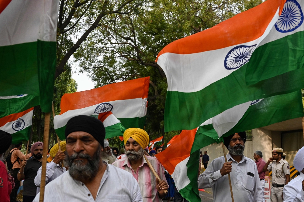 Sikh men hold Indian national flags during a protest against the supporters of radical Sikh preacher Amritpal Singh in New Delhi March 20, 2023. — AFP pic