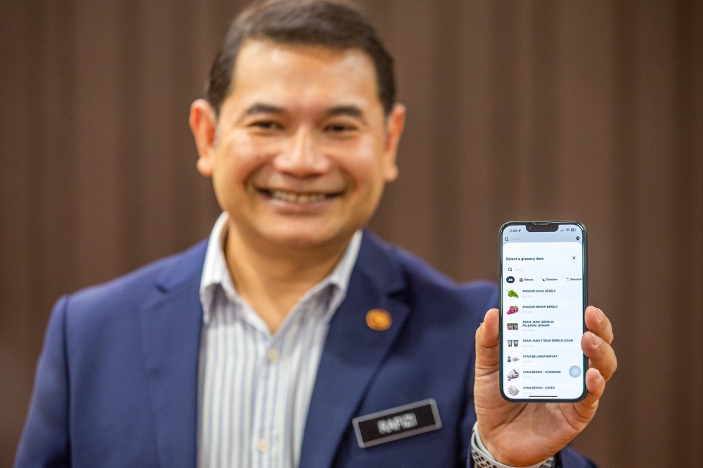 Minister of Economy, Rafizi Ramli showing the KitaJaga app during a press conference at Menara Prisma in Putrajaya March 27,2023. — Picture by Shafwan Zaidon