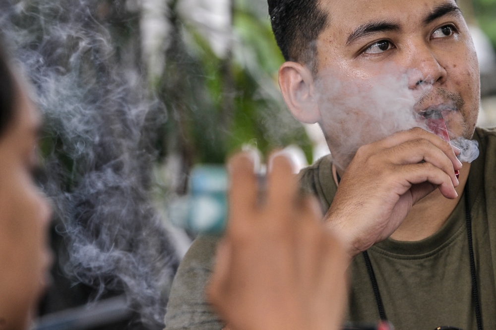 A man is seen vaping in Kuala Lumpur February 24, 2023. — Picture by Hari Anggara