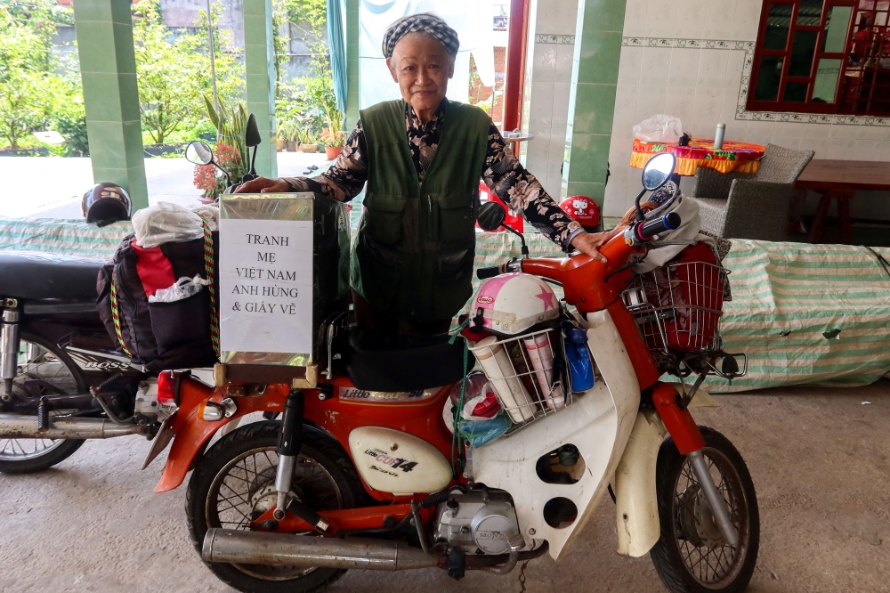 Vietnamese artist, Dang Ai Viet, poses with her motorcycle. — Reuters pic