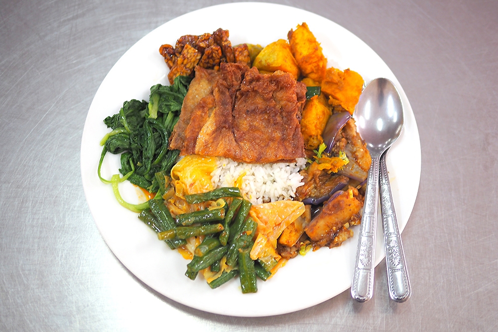 A plate of rice with my choice of vegetables, mock 'goose' and 'tempe' cost around RM11.