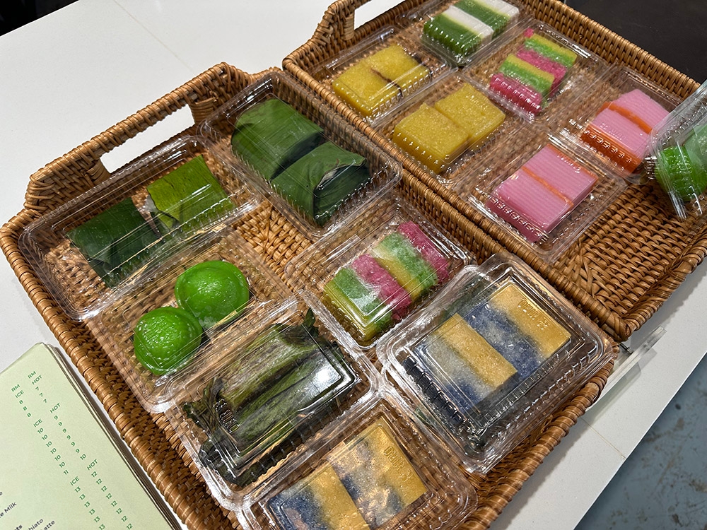 An assortment of Nyonya 'kuih' is available at the counter.