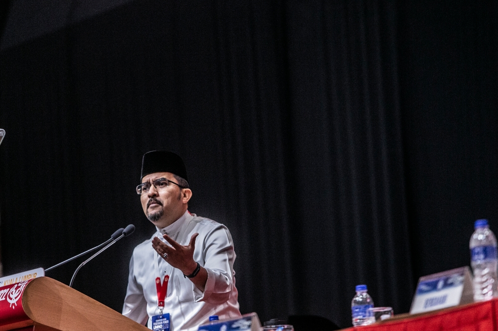 Umno Youth chief Datuk Asyraf Wajdi Dusuki delivers a keynote speech at the Umno Youth conference during the Umno's general assembly (PAU 2022) at World Trade Centre Kuala Lumpur January 12, 2023. — Picture by Hari Anggara