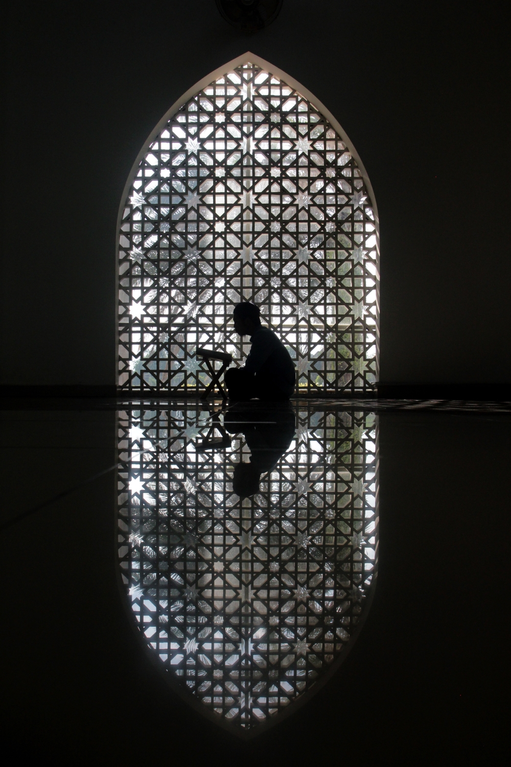 A Muslim reading the al-Quran at the Sultan Haji Ahmad Shah, Kuantan. — Bernama pic