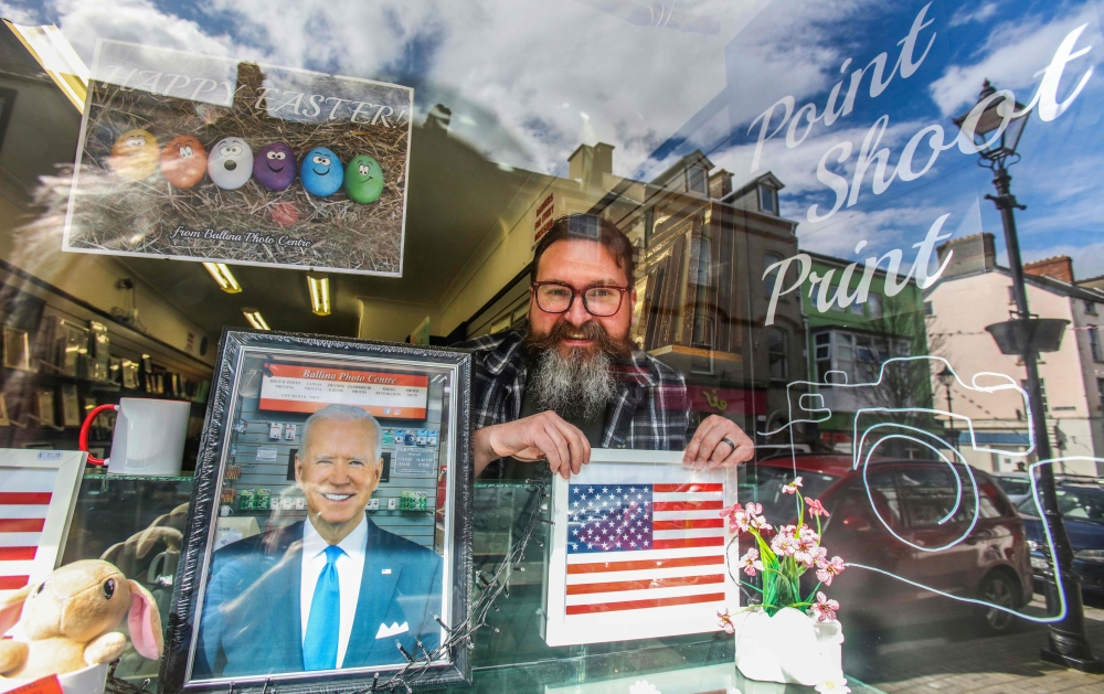 Derek Furlong poses in the window of his Ballina photo centre, as he and others dress up their business properties in Ballina town centre April 7, 2023. — AFP pic