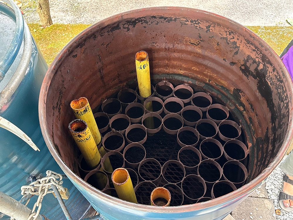 A rack placed inside the container allows about 30 bamboo cylinders to be cooked in one batch with a gas fire.