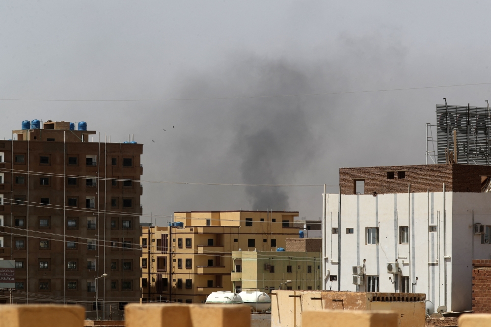 Smoke rises above buildings in Khartoum on April 15, 2023, amid reported clashes in the city. — AFP pic