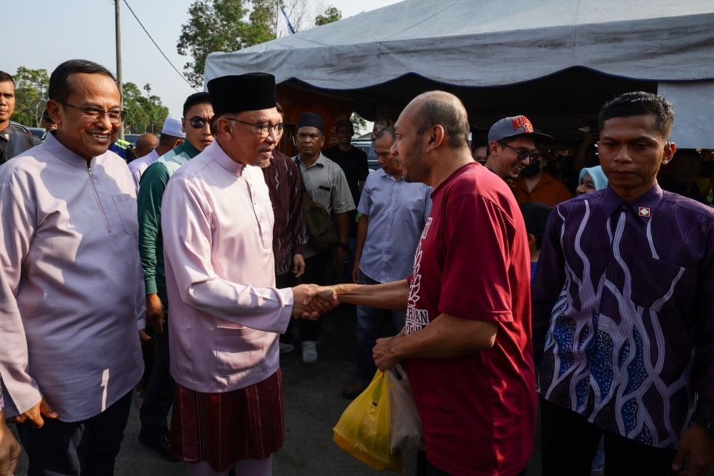 Prime Minister Datuk Seri Anwar Ibrahim (2nd left) greets members of the public at the Ramadan Bazaar in Gong Badak, Kuala Nerus April 15, 2023. — Bernama pic