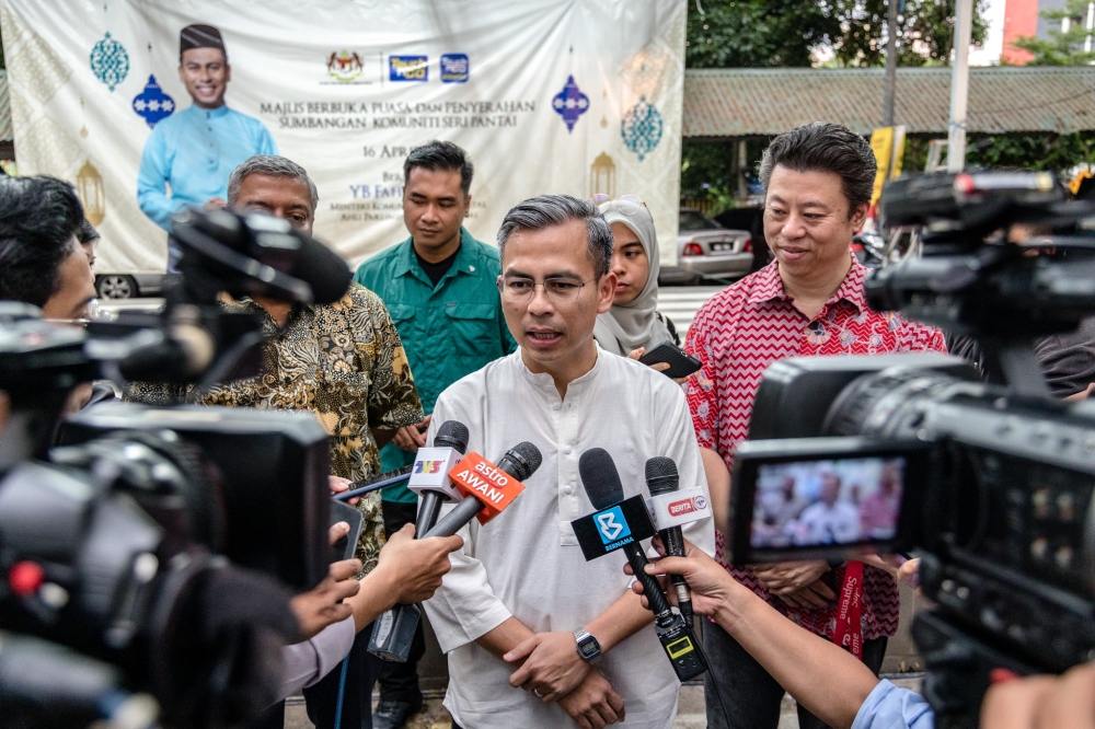 Communications and Digital Minister Fahmi Fadzil speaking to reporters at the community contribution programme and breaking fast at PPR Sri Pantai in Kuala Lumpur, April 16, 2023. — Picture YB Firdaus Latif