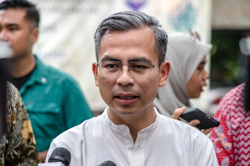 Communications and Digital Minister Fahmi Fadzil speaks to reporters at the community contribution programme and breaking fast at PPR Sri Pantai in Kuala Lumpur April 16, 2023. — Picture by Firdaus Latif