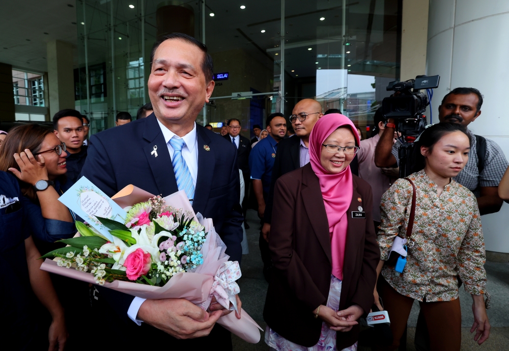 Health director-general Tan Sri Dr Noor Hisham Abdullah (left) leaves the Health Ministry in Putrajaya April 19, 2023. Also present is Health Minister Dr Zaliha Mustafa. — Bernama pic